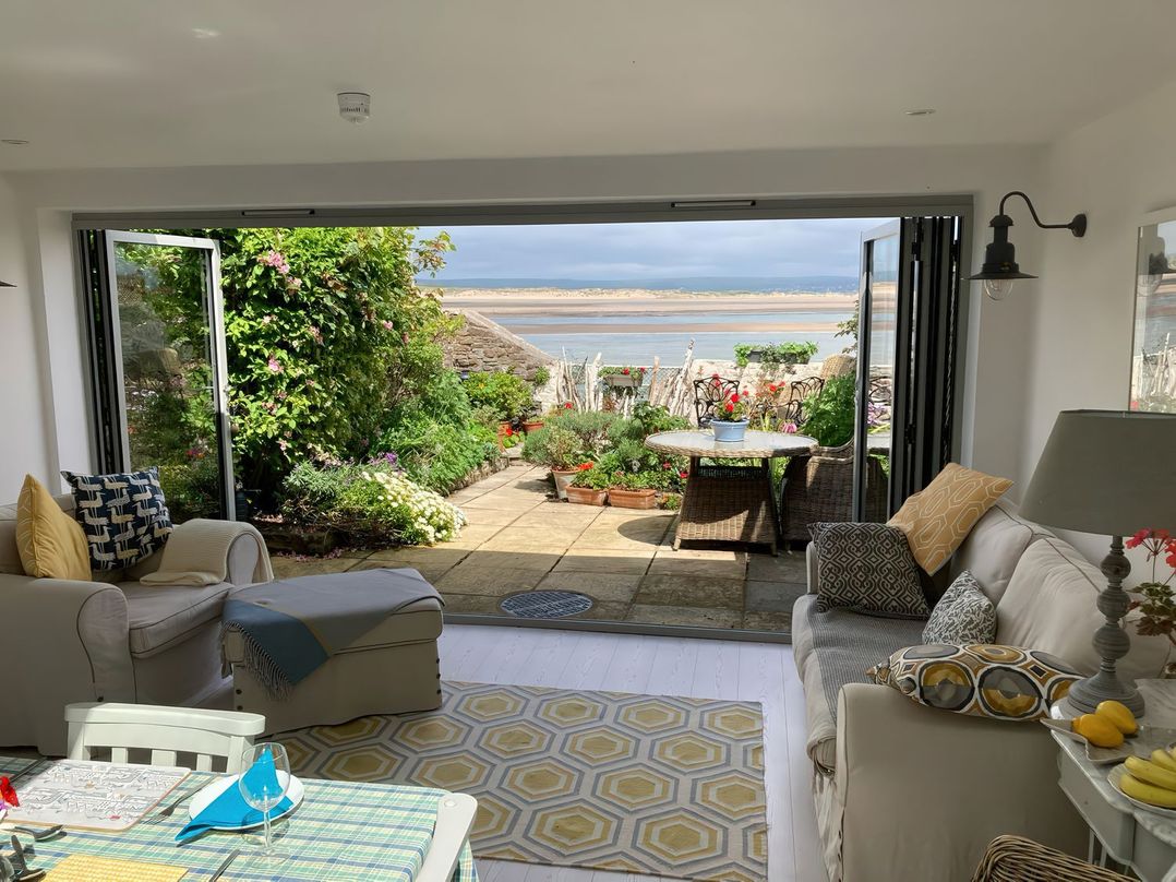 A living room with a view of a garden at Mariners Cottage in Bideford