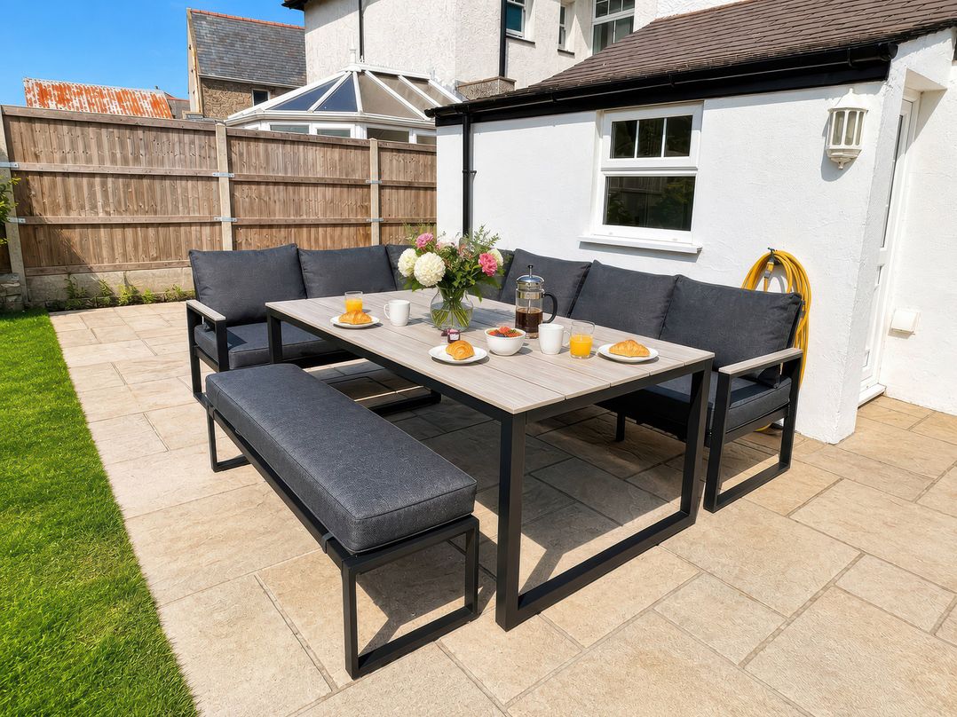 An outdoor dining area with table and seating at Bryniau Morfa Nefyn