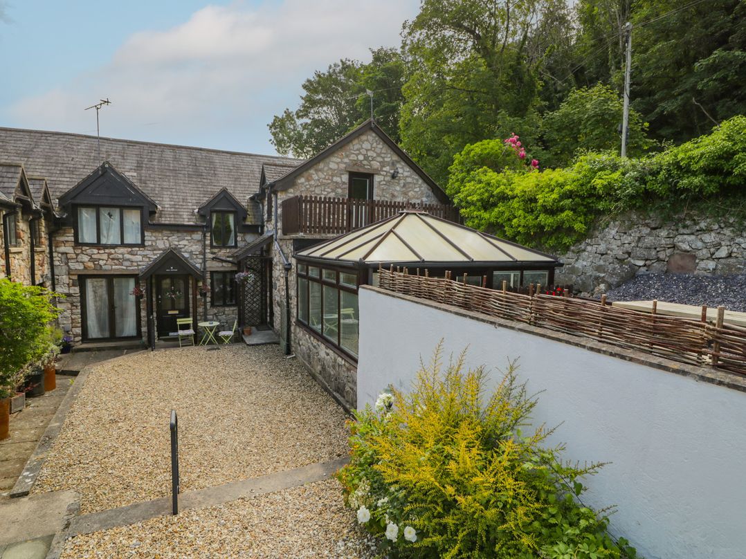A house with a garden and gravel area at Ivy Cottage Abergele