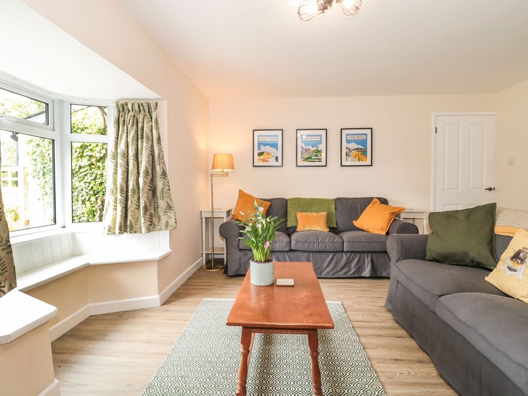 A living room with sofas and a coffee table at Ammerham Farm Cottage in Ammerham near Winsham