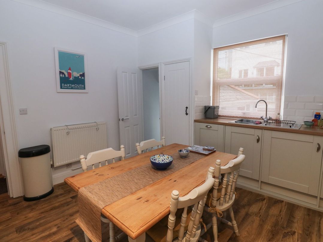A kitchen with a table and chairs at The English School, Flat 2 Dartmouth