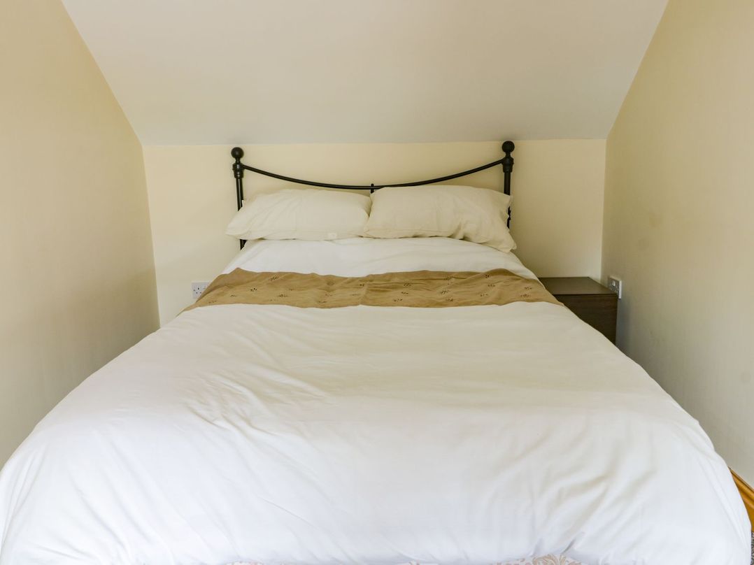 A bed with pillows and a blanket at Lavender Lodge in Hull
