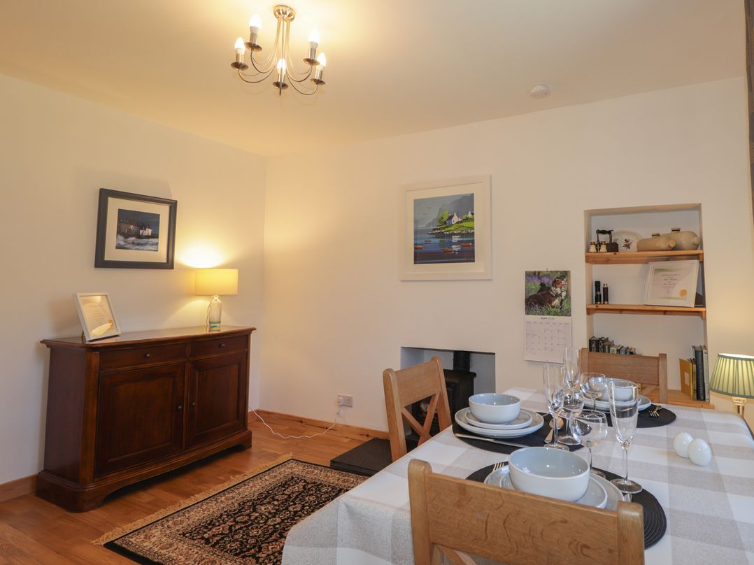 A dining room with a table set for meals at Tigh a Phailean in Letterfearn