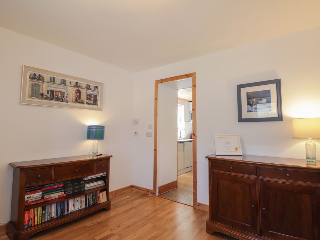 A living room with a sideboard and a doorway at Tigh a Phailean in Letterfearn