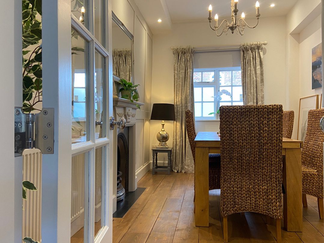 A dining room with a table and chairs at 19 Queen Street Emsworth