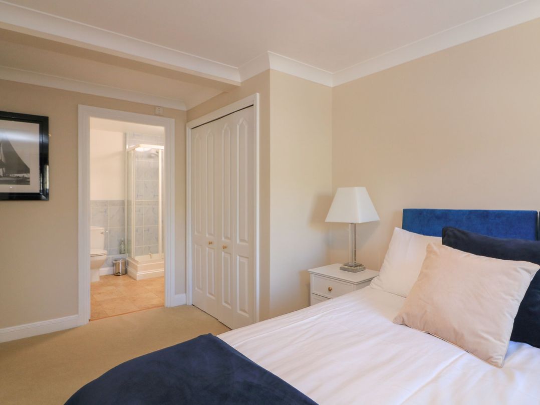 A bedroom with a bed and attached bathroom at 6 Dartmouth House in Dartmouth