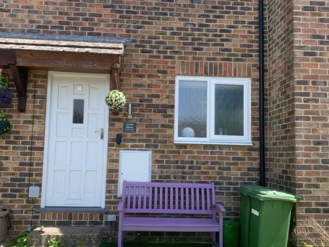 An entrance with a door and window at Amber House in Dorchester