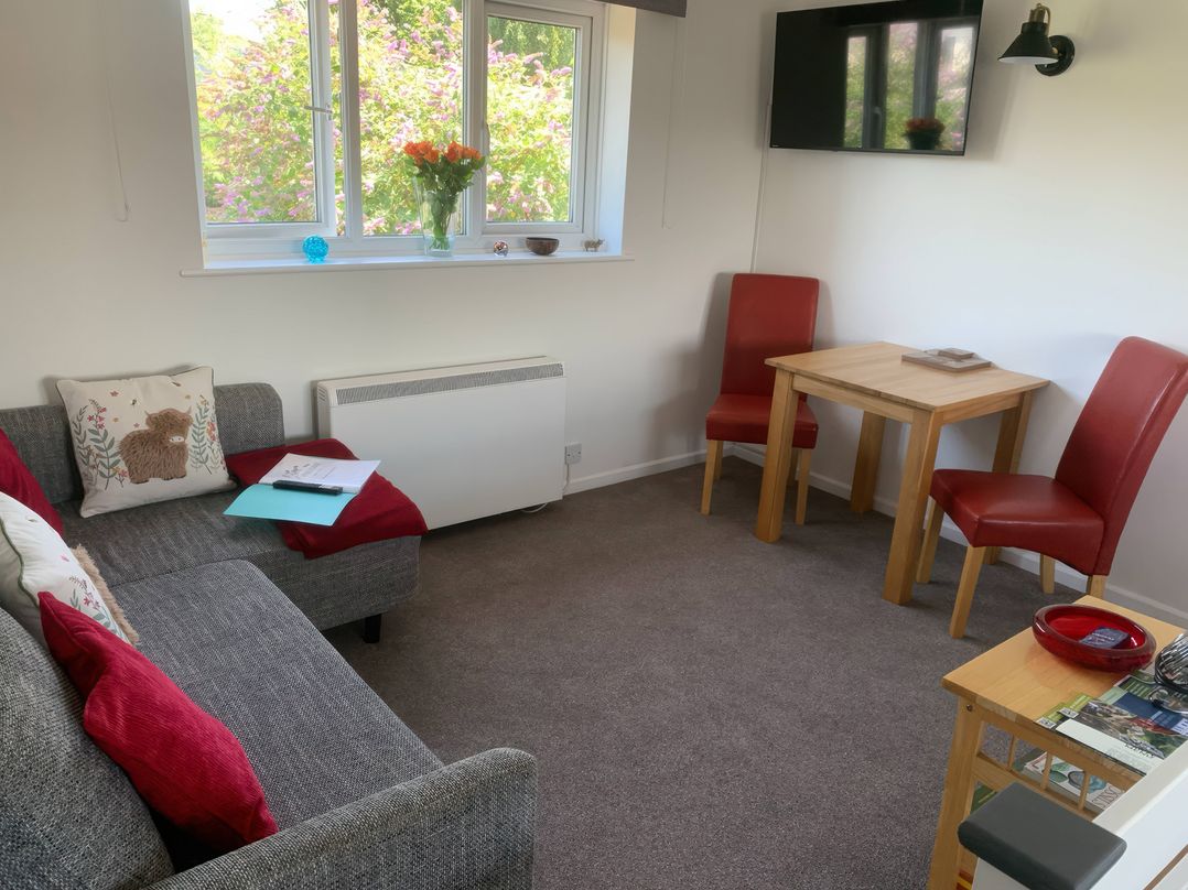 A living room with a sofa and table at Amber House in Dorchester