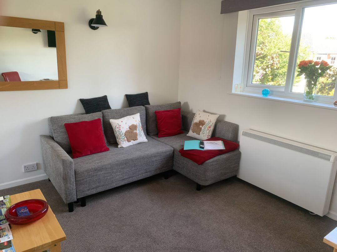 A living room with a sofa and window at Amber House Dorchester