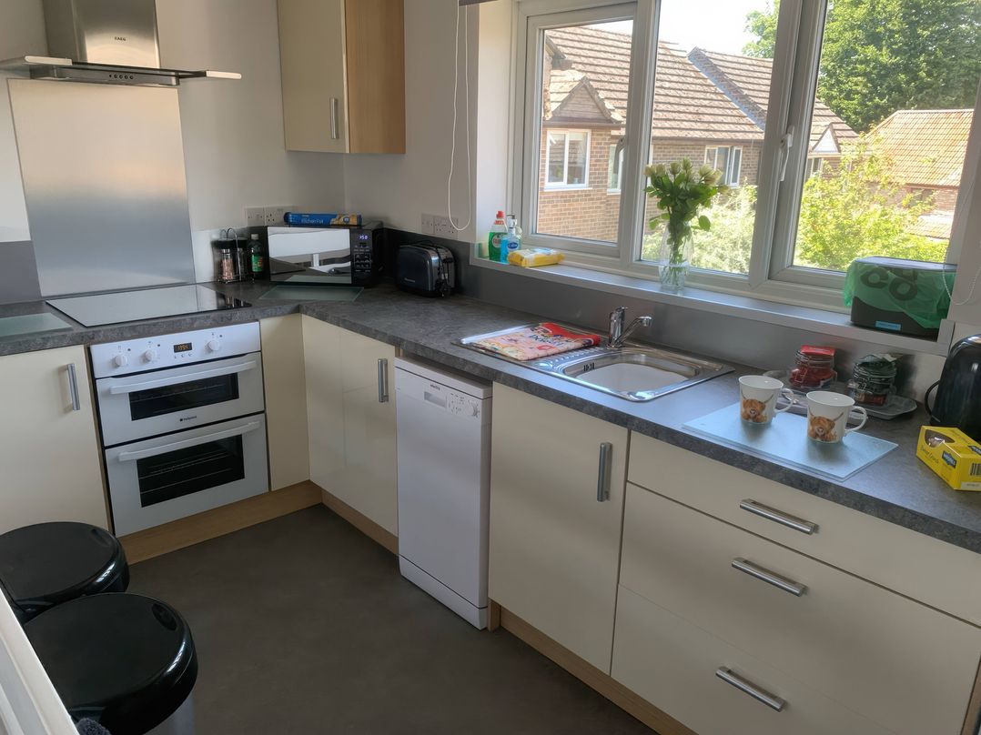A kitchen with cabinets and appliances at Amber House in Dorchester