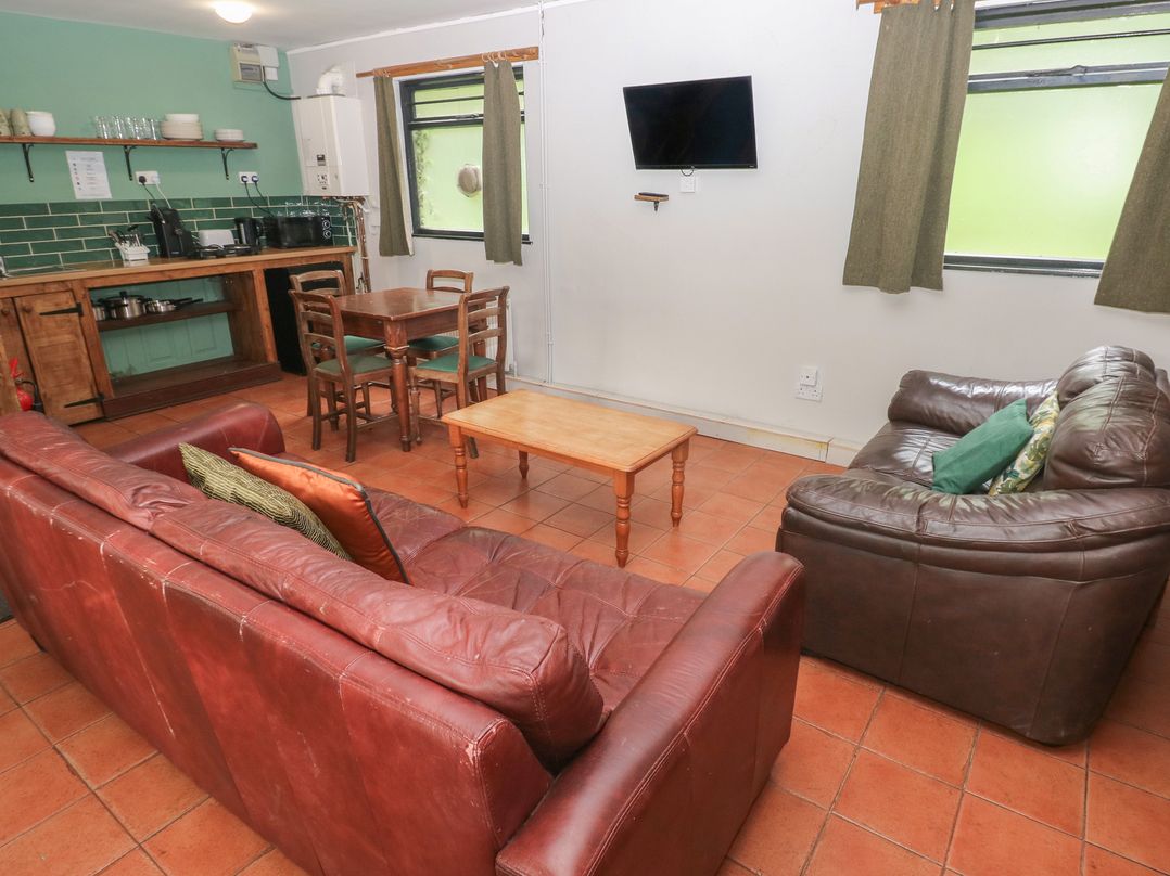 A living room with a sofa and coffee table at Cabin No. 10 - Salt and Fern Cabins Goytre near Port Talbot
