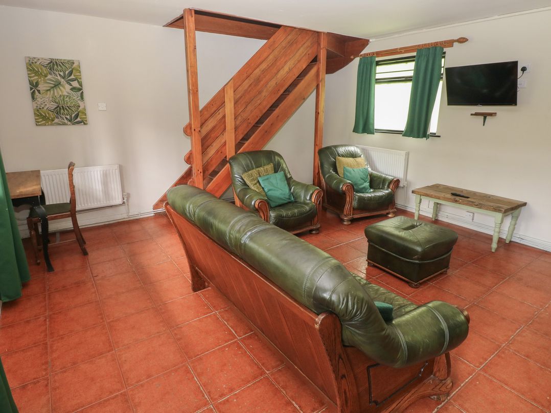 A living room with a sofa and two armchairs at Cabin No. 12 - Salt and Fern Cabins Goytre near Port Talbot