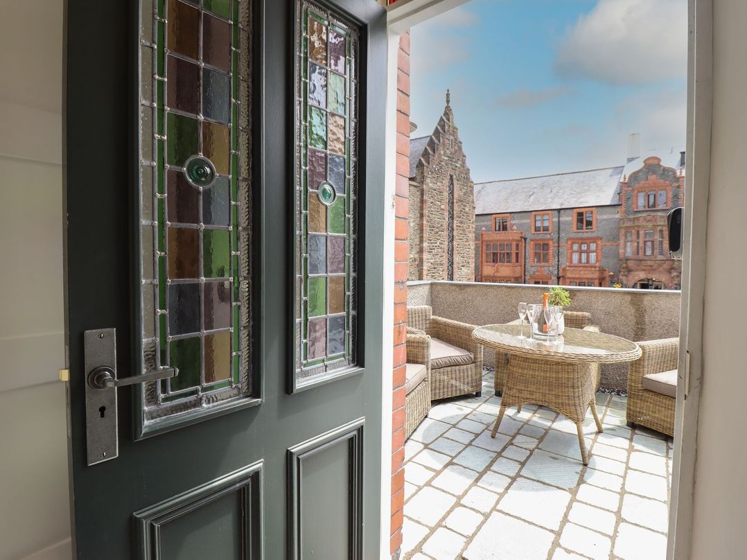 A balcony view with a table and chairs at 2 Llewelyn Street in Conwy