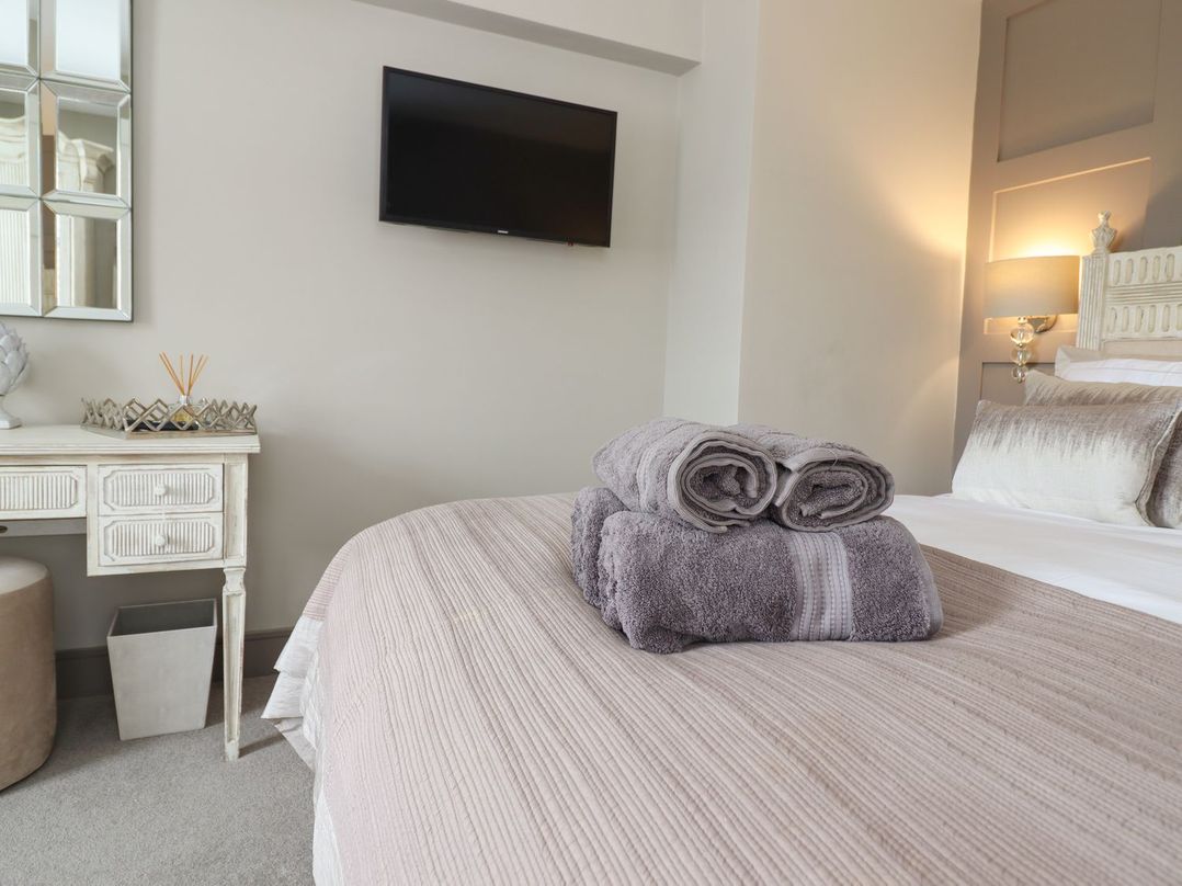 A bedroom with a bed and towels on it at 2 Llewelyn Street in Conwy
