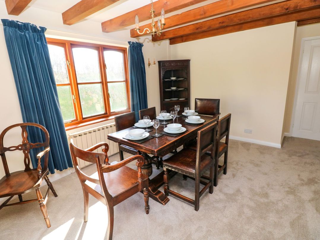 A dining room with table and chairs at Park Hall Cottage in Solva