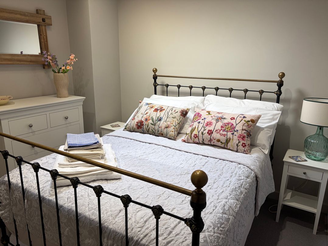 A bedroom with a bed and dresser at The Cottage at Thorpe Farm Appleton-le-Moors near Kirkbymoorside