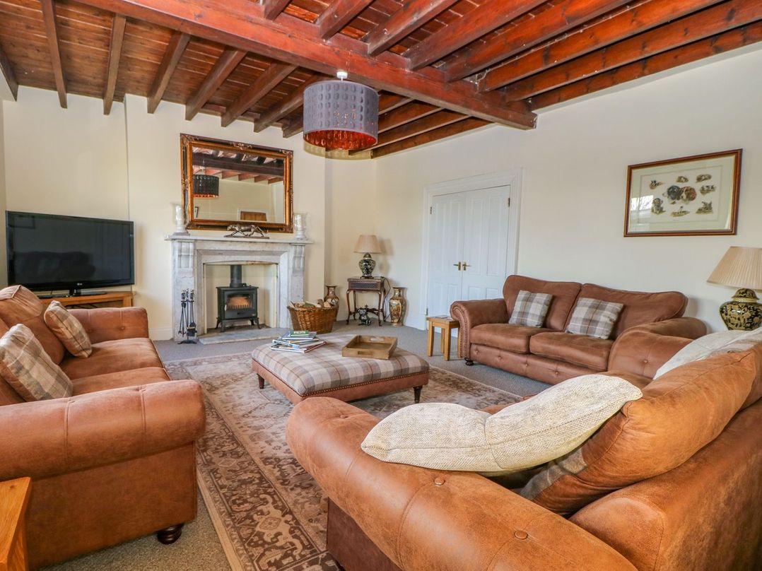 A living room with a sofa and television at Tuft House in Hovingham