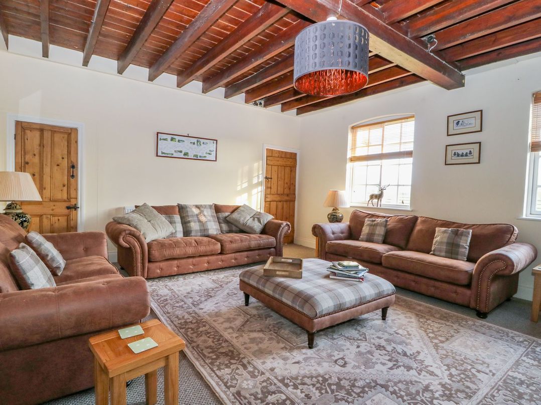 A living room with sofas and a coffee table at Tuft House in Hovingham