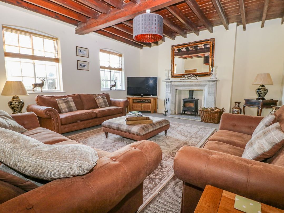 A living room with a sofa and television at Tuft House in Hovingham