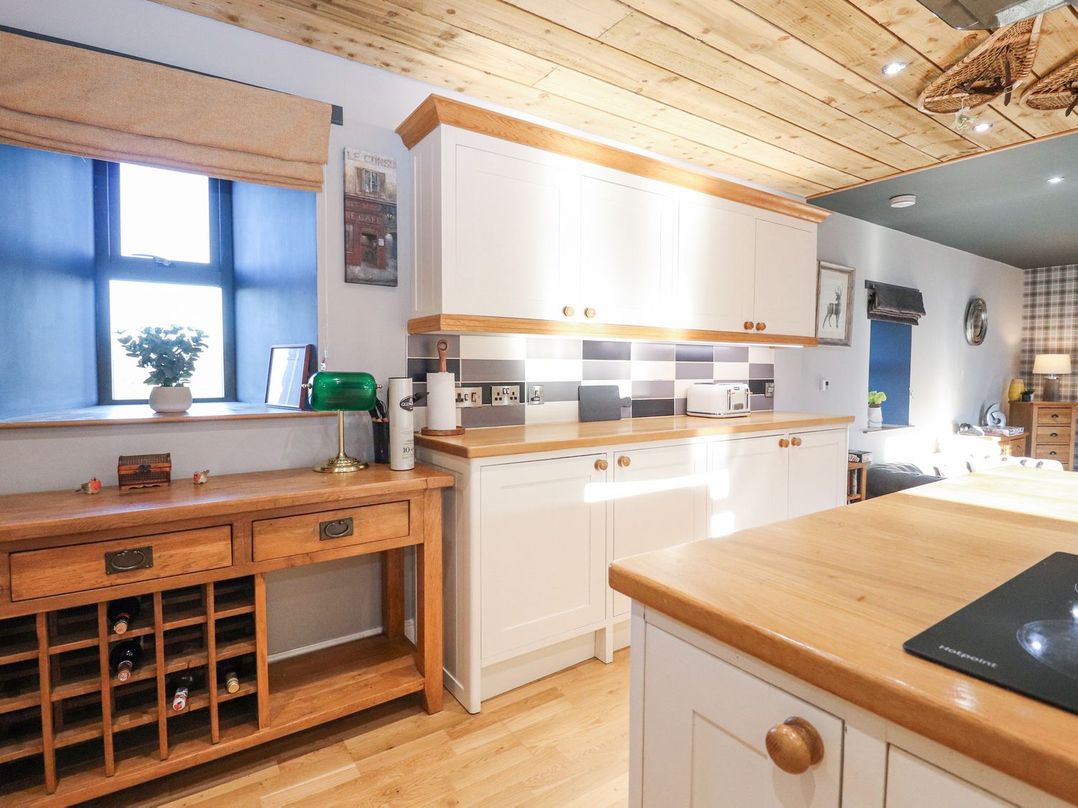 A kitchen with a wine rack and countertop at The Steading in Dumfries