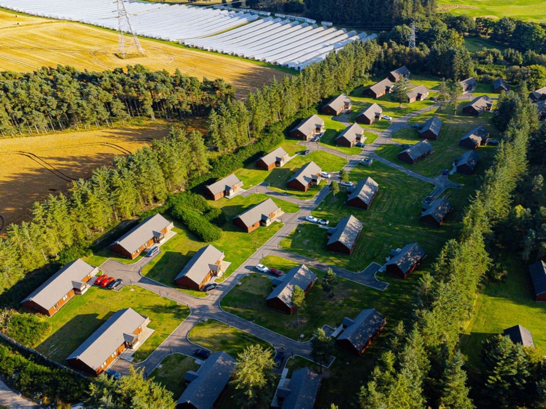 An aerial view of a group of cabins at Sidlaw Spa (Pet) Fowlis near Dundee