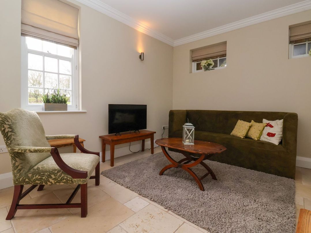 A living room with a sofa and coffee table at The Bothy in Knaresborough