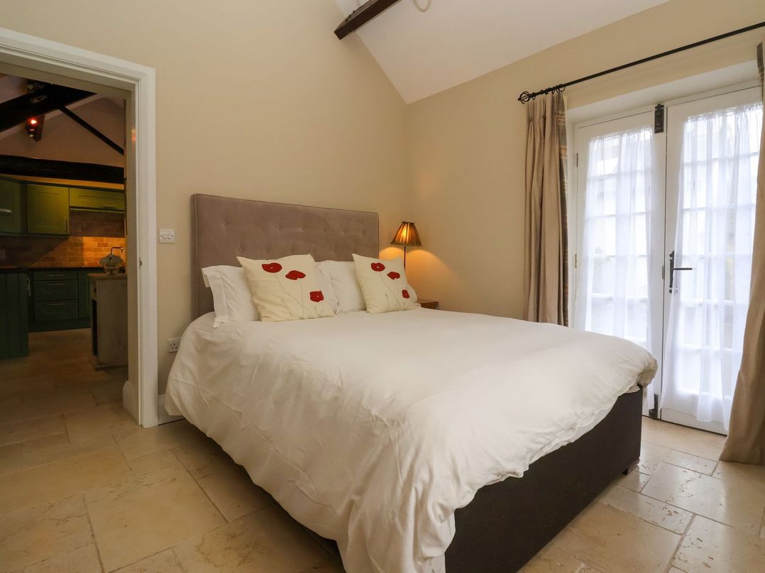 A bedroom with a bed and light fixture at The Bothy in Knaresborough