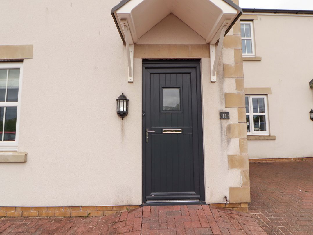 An entrance with a dark door and lantern at 11 The Forge Brampton
