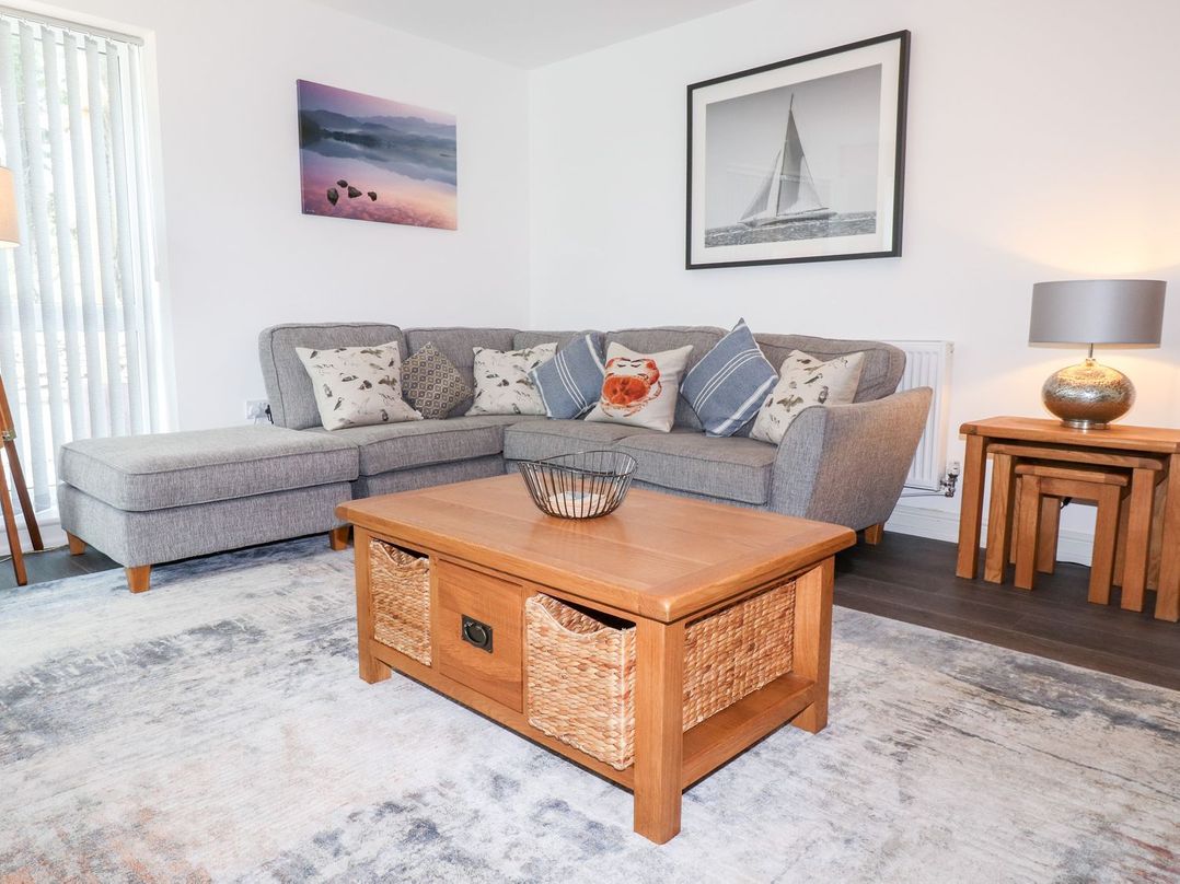 A living room with a sofa and coffee table at Seagull Shack Morfa Bychan