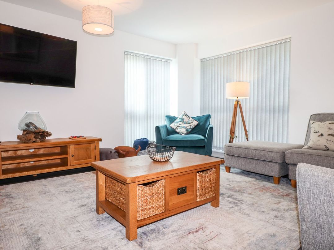 A living room with furniture including a sofa and coffee table at Seagull Shack in Morfa Bychan