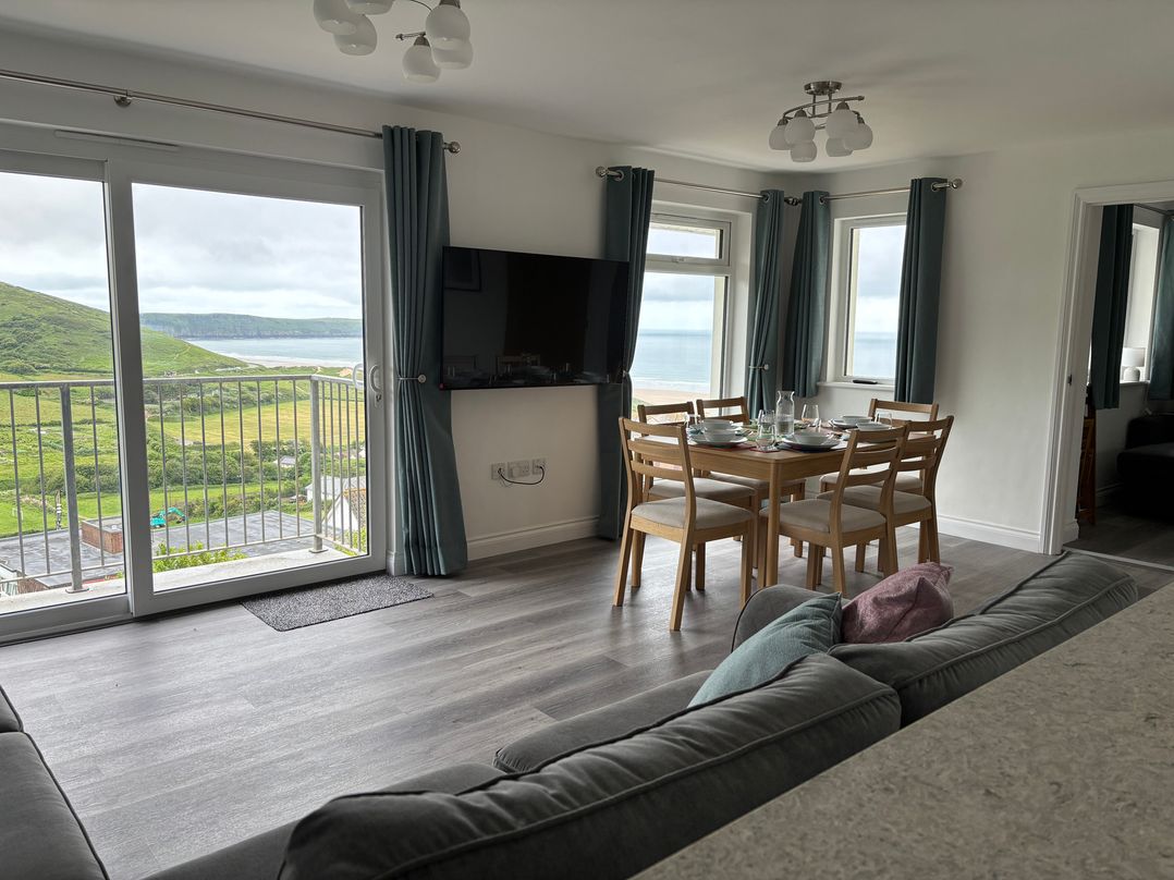 A living room with a dining area and view at Belvedere in Woolacombe