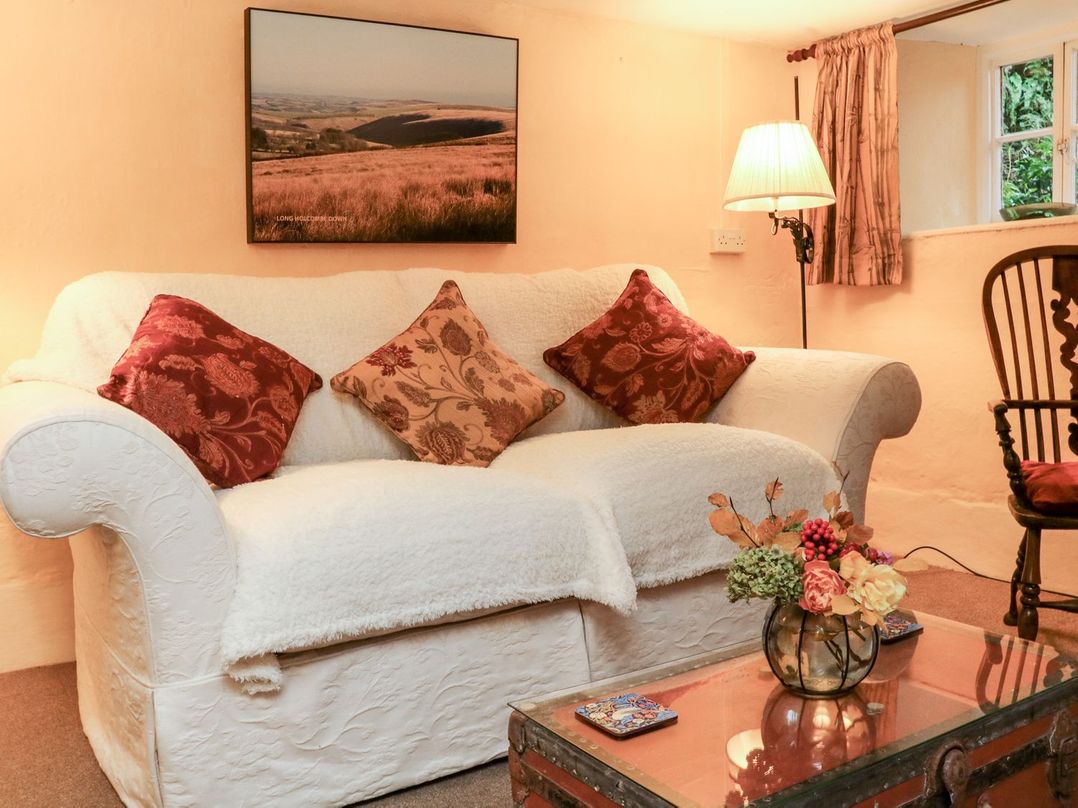 A living room with a sofa and coffee table at Whitefield Cottage in Barnstaple