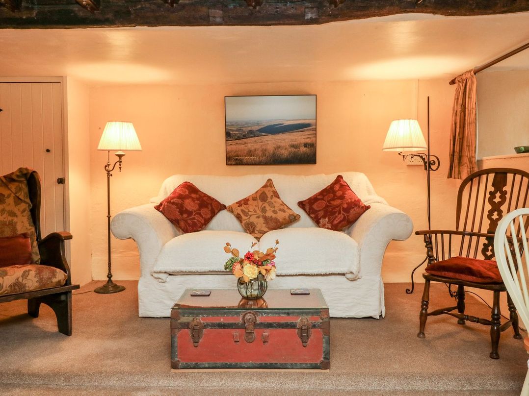 A living room with a sofa and a table at Whitefield Cottage in Barnstaple
