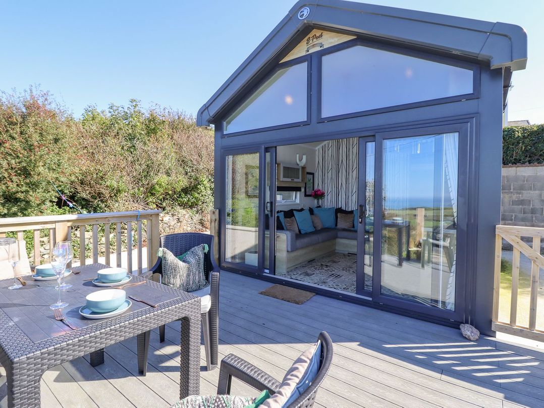 A snug with a seating area and outdoor dining at Posh Pod in Cemaes Bay