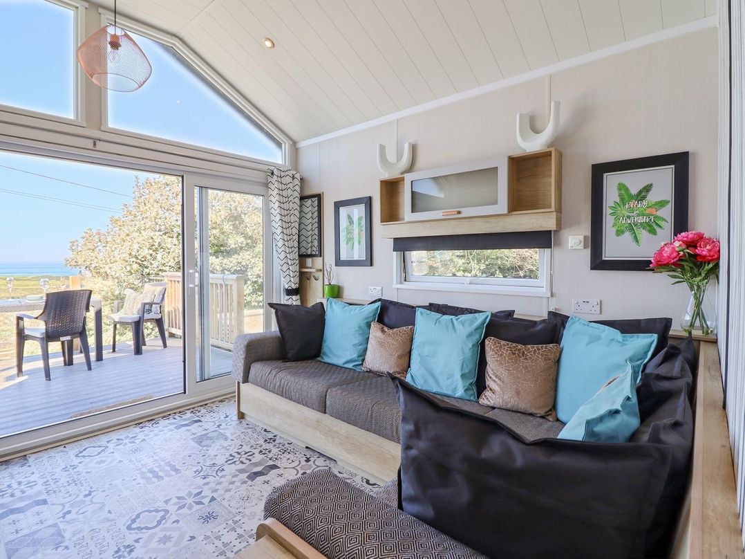 A living room with a sofa and coffee table at Posh Pod in Cemaes Bay