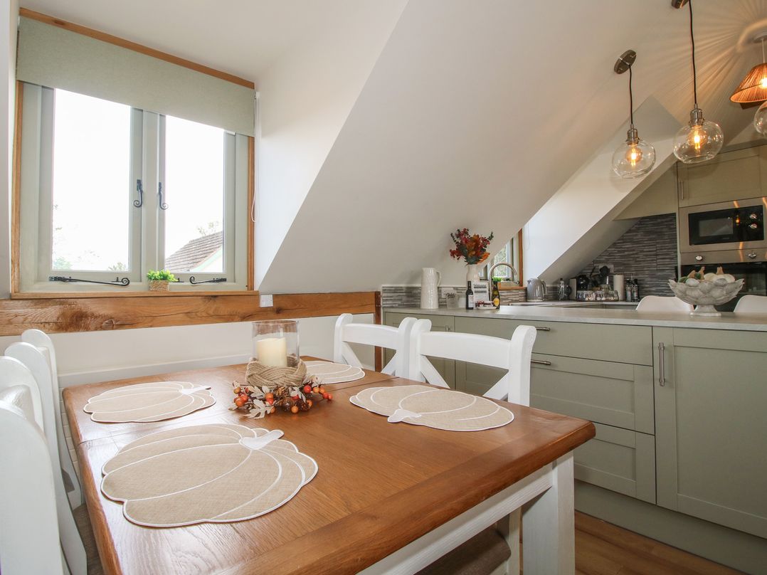 A kitchen with a dining table and chairs at Little Acre in Leominster