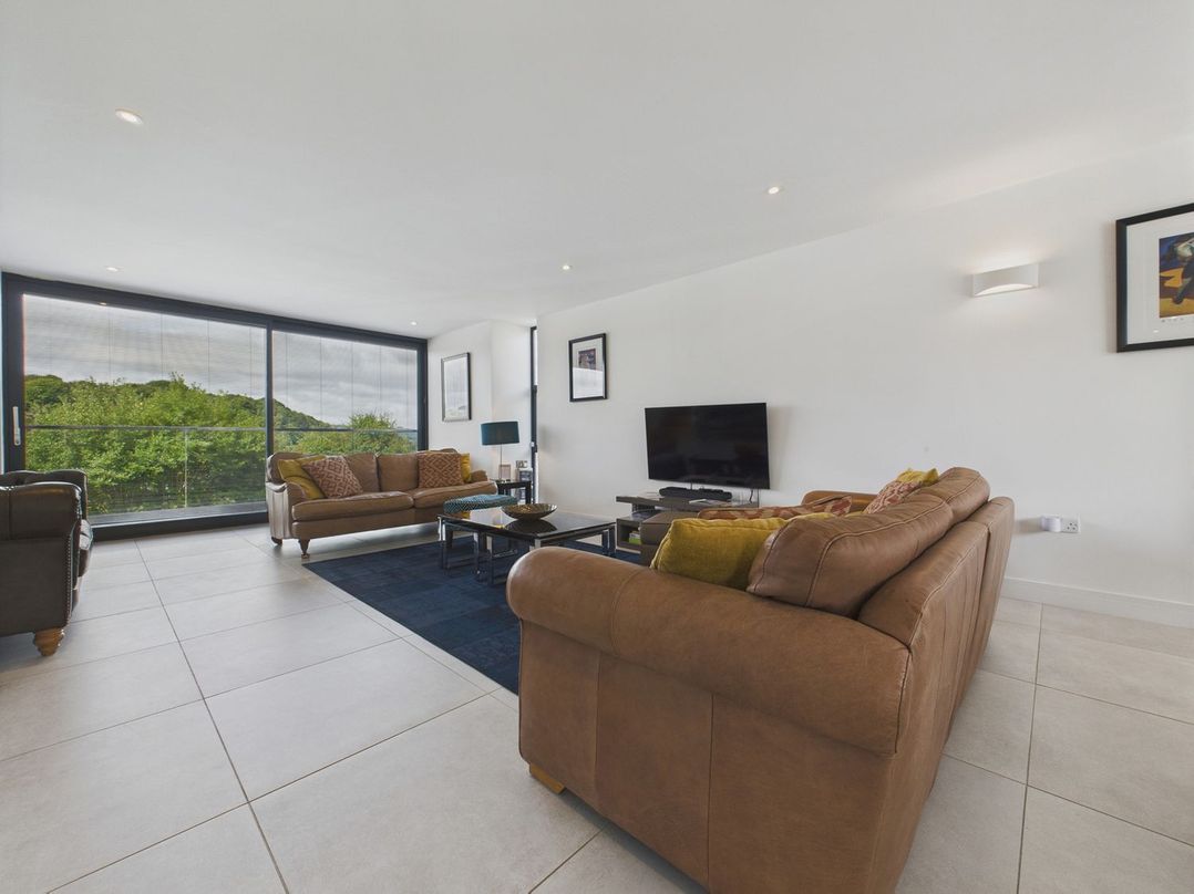 A living room with two sofas and a television at Oakwood House in Tansley near Matlock
