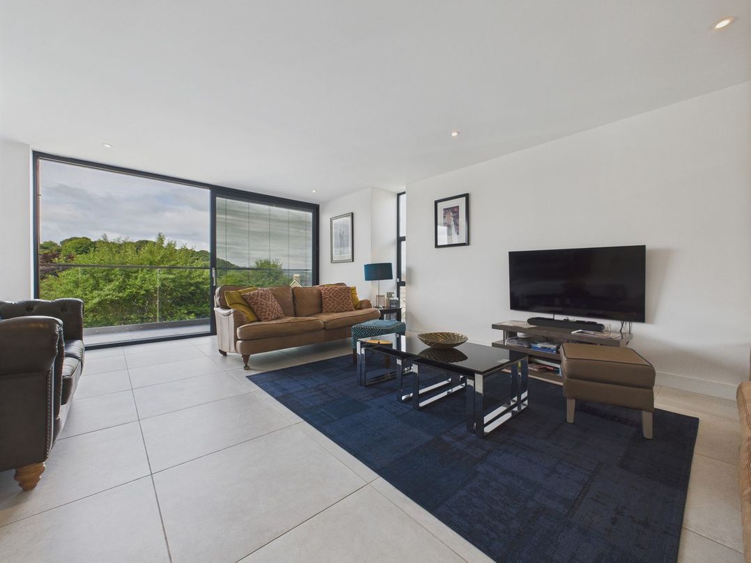 A living room with a sofa and a television at Oakwood House in Tansley near Matlock