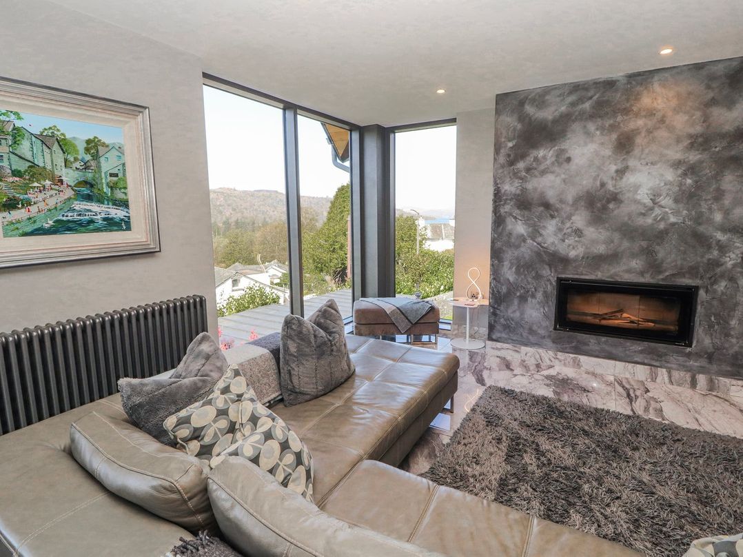A living room with a sofa and painting at Midways in Windermere