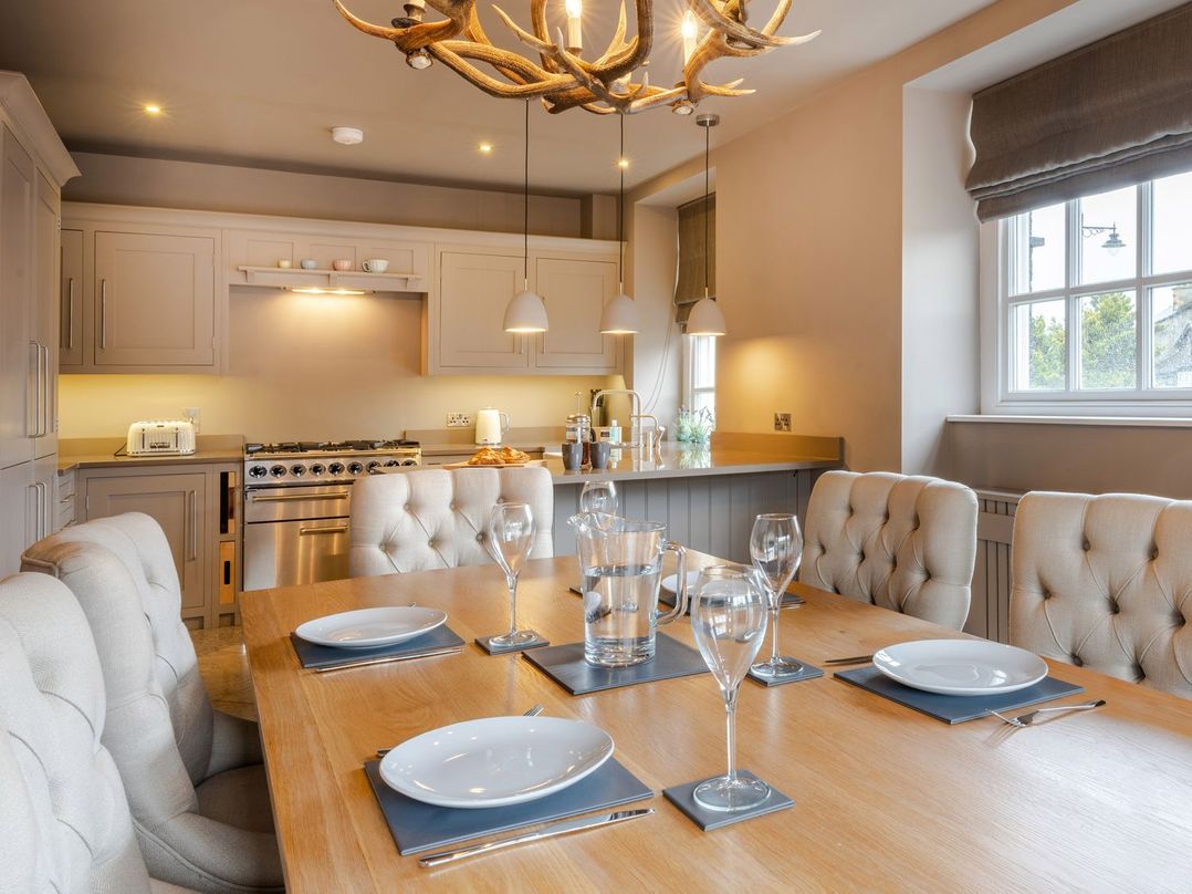 A dining room with a table and chairs at Prospect House in Windermere