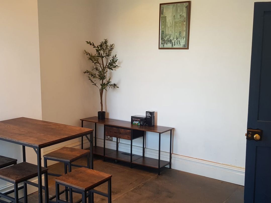 A dining room with a table and chairs at Ehen Cottage in Cleator Moor