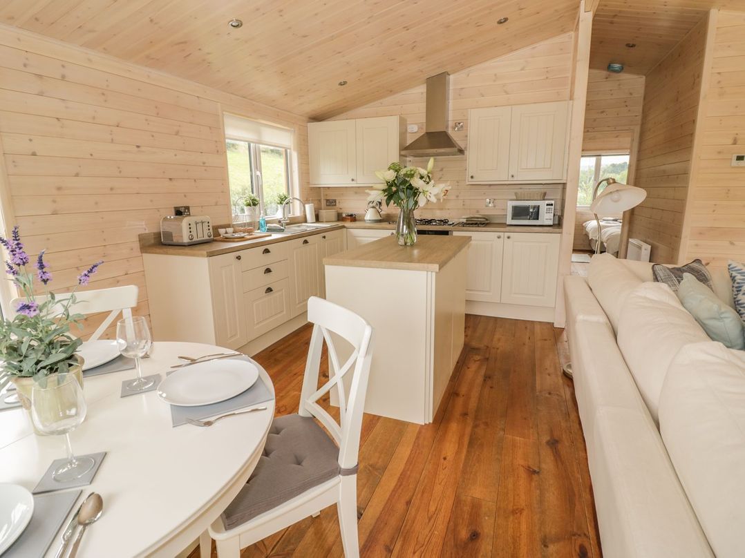 A kitchen with a dining area and sofa at Mallard in Ross-on-Wye
