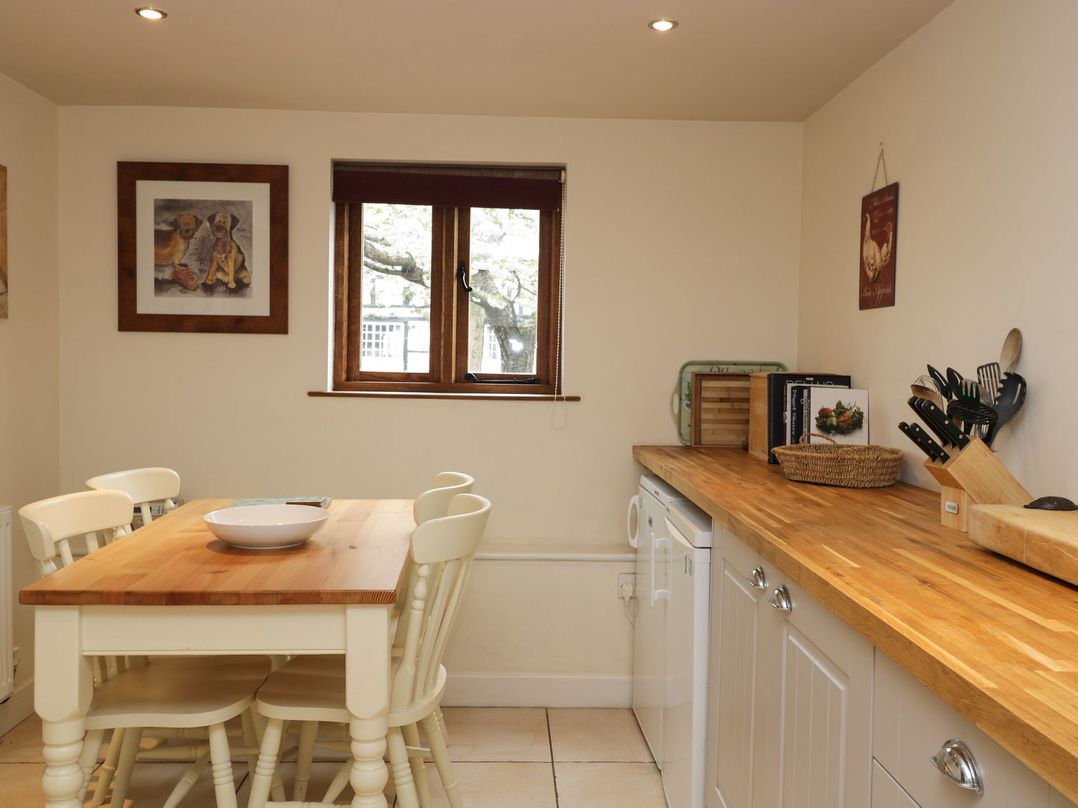 A kitchen with a table and chairs at The Old Barn in Hereford