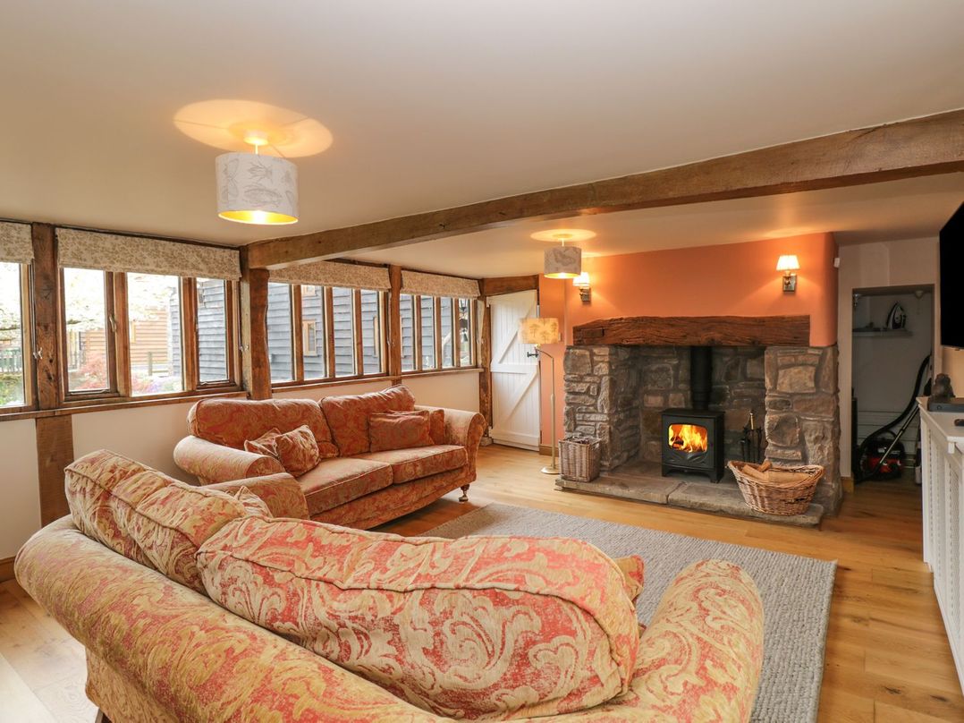 A living room with a fireplace and sofas at The Granary in Hereford