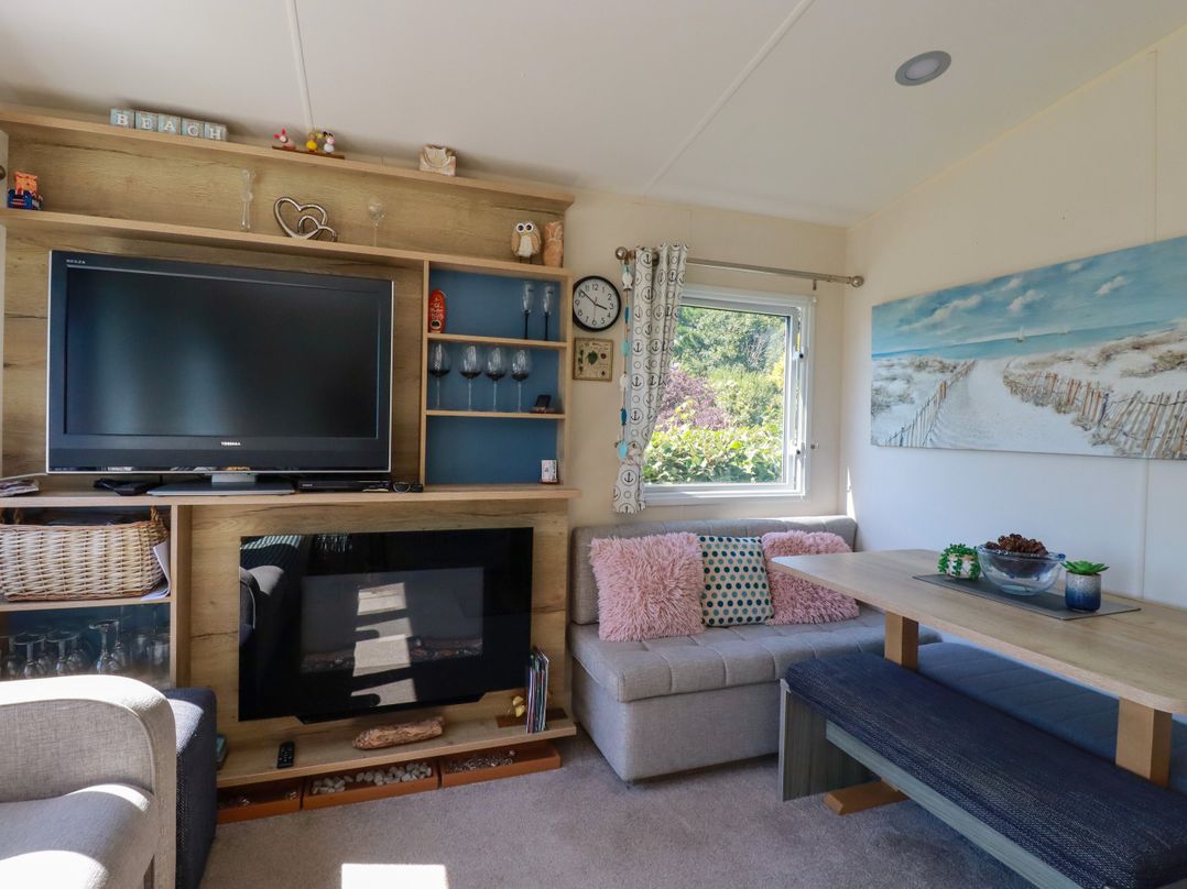 A living room with a television and sofa at Porthcurno 5 Perranwell near Goonhavern