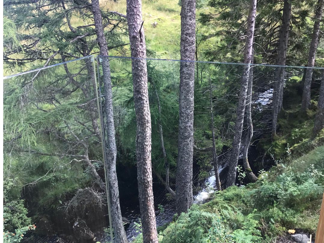Red Stag with stunning loch and waterfall view