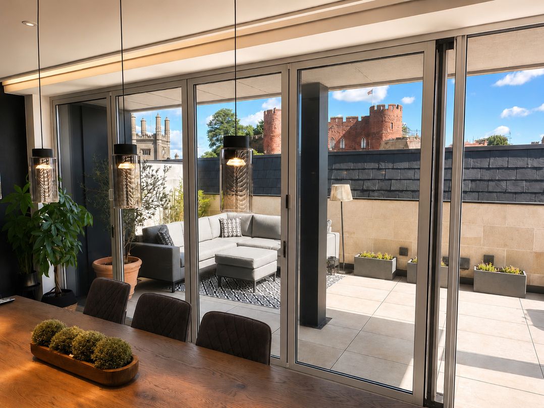 A living room with a sofa and dining table at Luxury two story Penthouse with roof top terrace, Shrewsbury