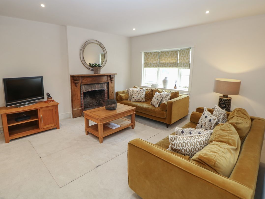 A living room with a television and a sofa at Lion House in Ashbourne