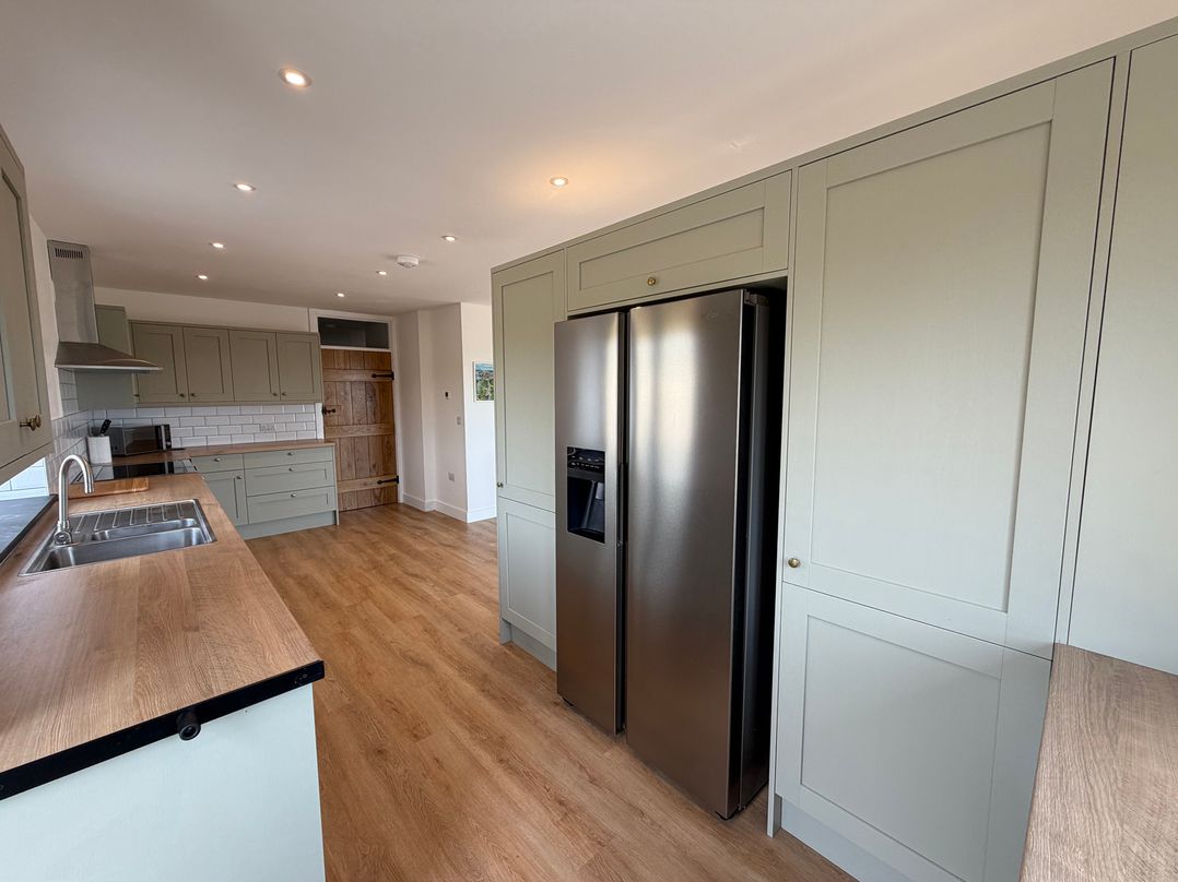 A kitchen with a refrigerator and sink at High View Barn in Launceston