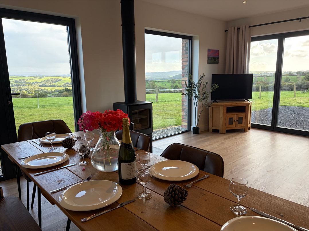 A dining room with a table set for a meal at High View Barn in Launceston